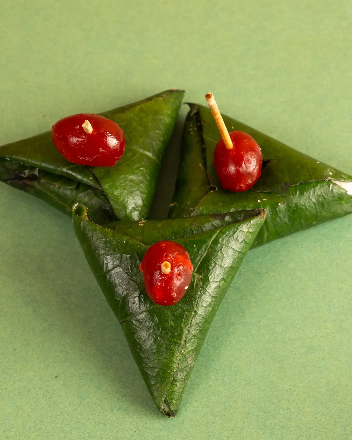 Traditional green paan topped with cherries